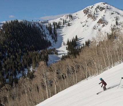 Friends enjoy a ski day together under the sun in Park City, UT.
