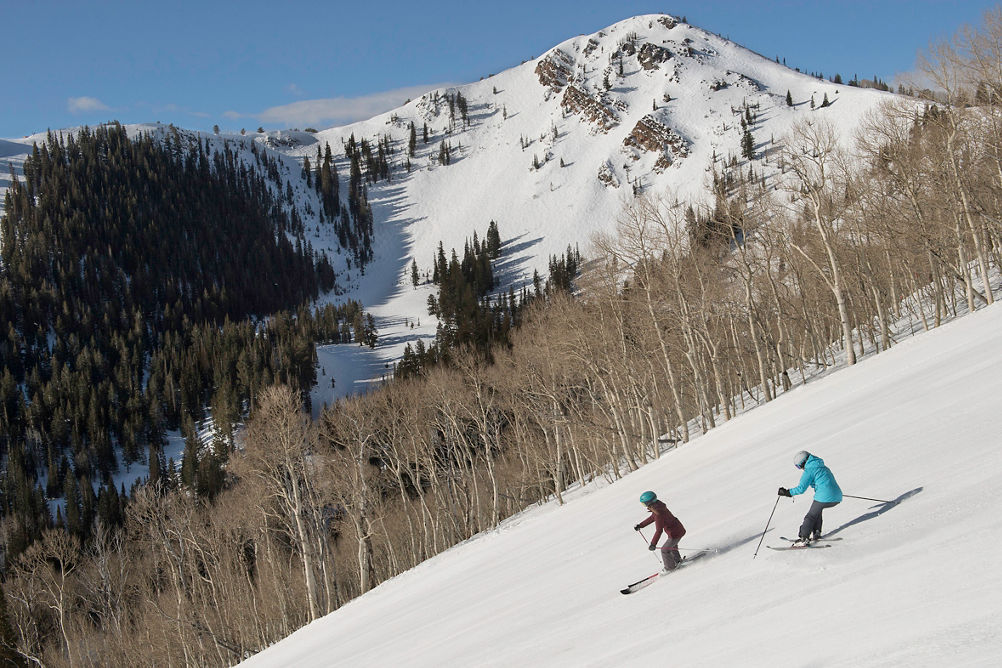 Friends enjoy a ski day together under the sun in Park City, UT.