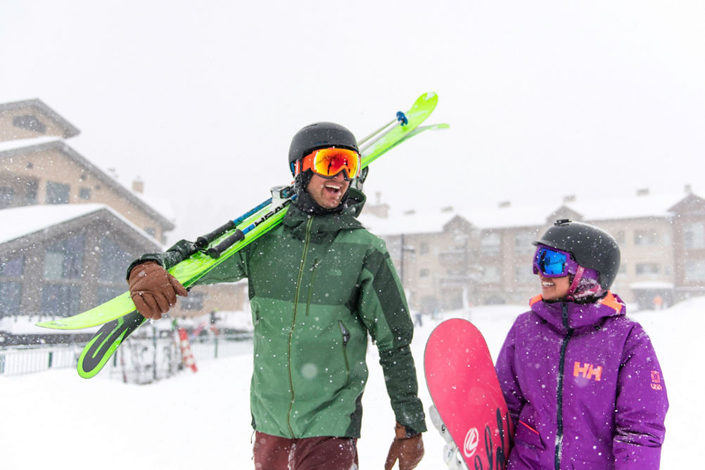 Couple walks through the snow to the mountain in Kirkwood, CA.