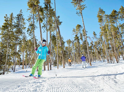 Family has a ski day together on the mountain in Keystone, CO.