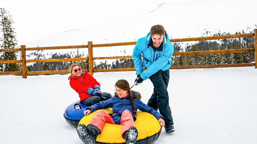Friends play at the tubing hill in Keystone, CO.