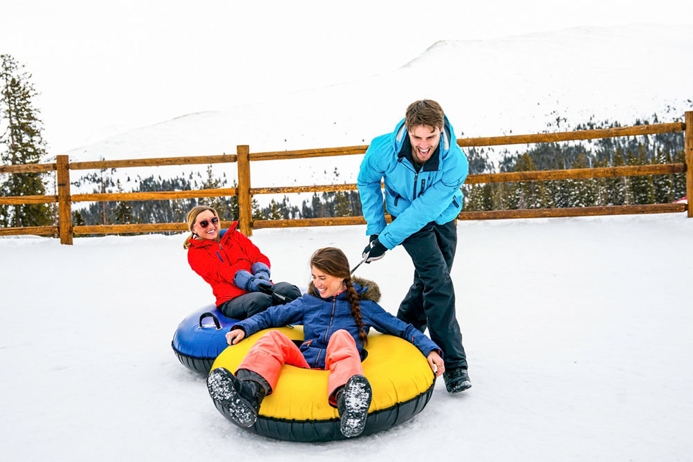 Friends play at the tubing hill in Keystone, CO.