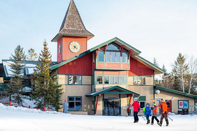 Family Walks in Front of Clocktower at Mount Snow