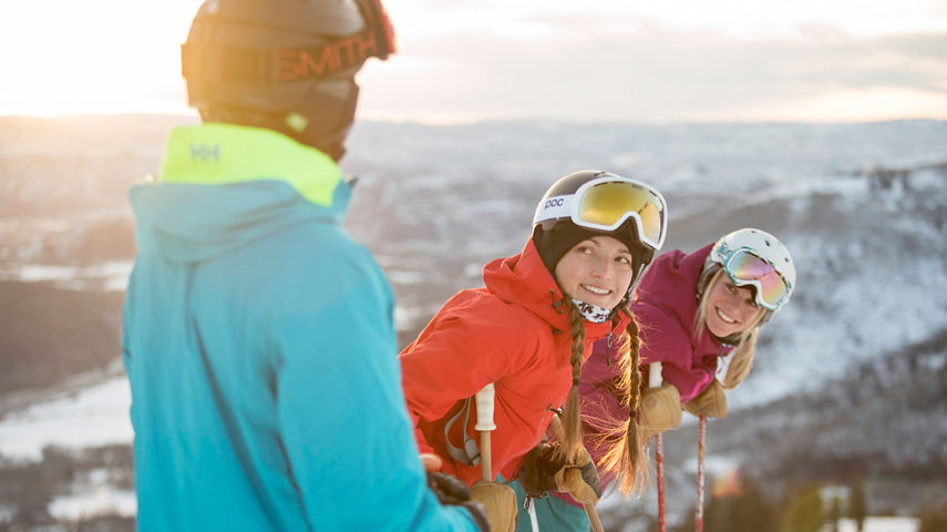 Friends ski together under the sun in Park City, UT.