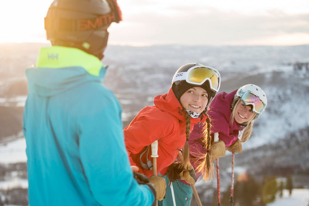 Friends ski together under the sun in Park City, UT.
