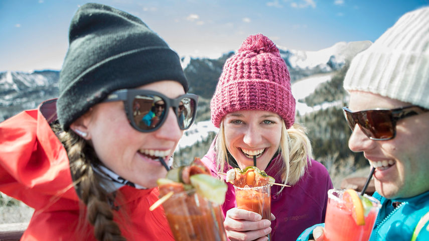Friends enjoy apres on top of the mountain in Park City, UT.