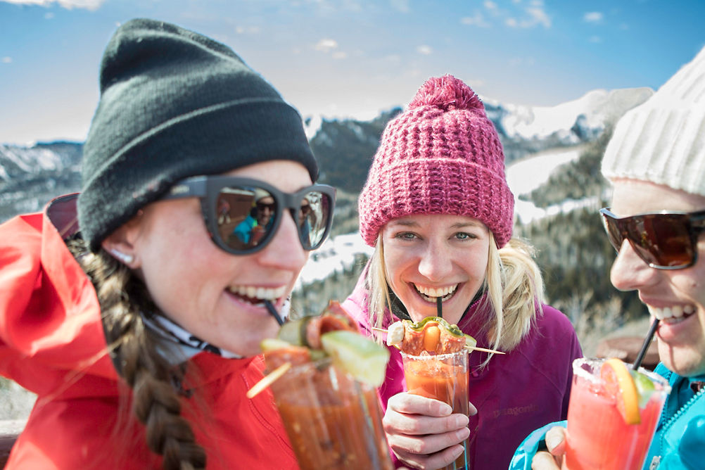 Friends enjoy apres on top of the mountain in Park City, UT.