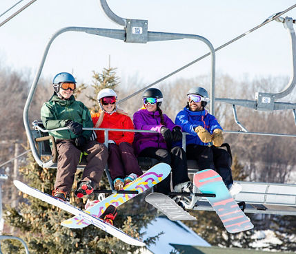 Group of friends enjoy snowboard experience in Mt. Brighton, MI.