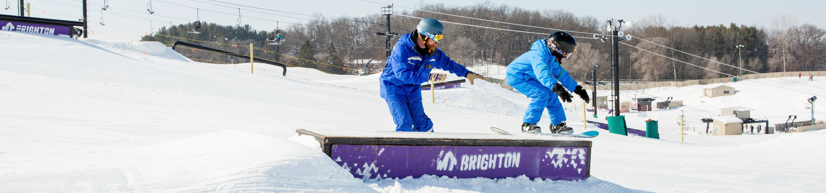 Kid's snowboard school in the terrain park at Mt. Brighton, MI.