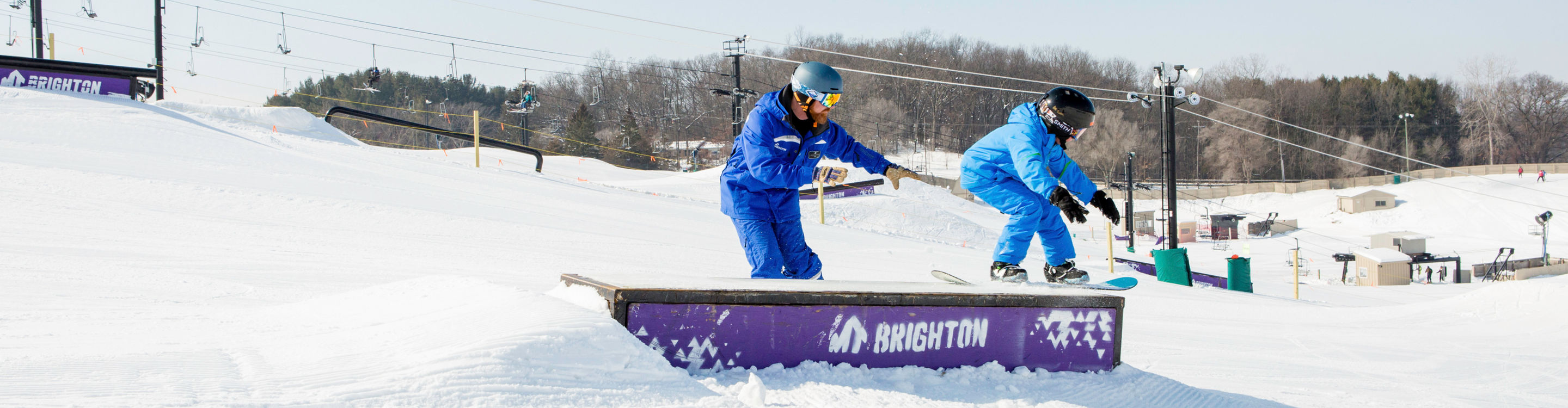 Kid's snowboard school in the terrain park at Mt. Brighton, MI.