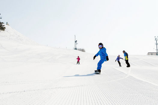 Kid's snowboard school lesson in Mt. Brighton, MI.