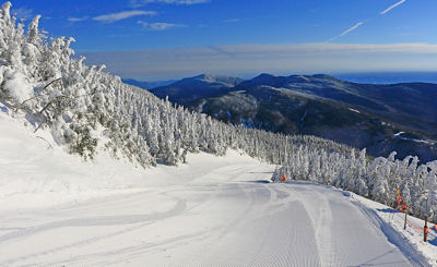 Groomed trail amongst fresh snow in Stowe, VT.