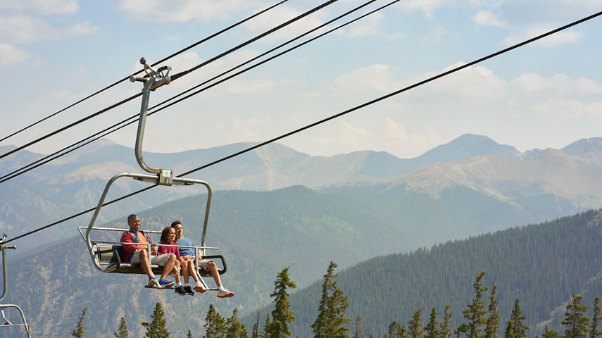 Family rides Summit Express chairlift in Keystone, CO.