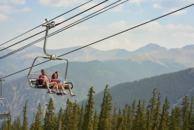 Family rides Summit Express chairlift in Keystone, CO.