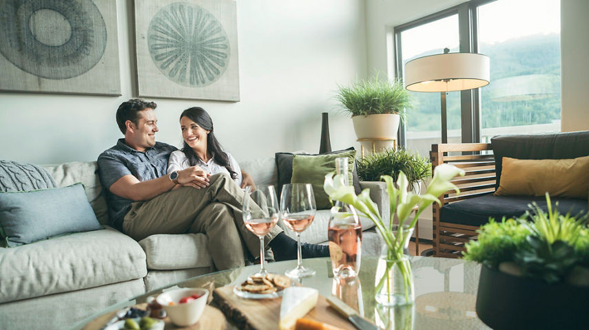 Couple relaxes with wine and cheese at The St James in Beaver Creek, CO.