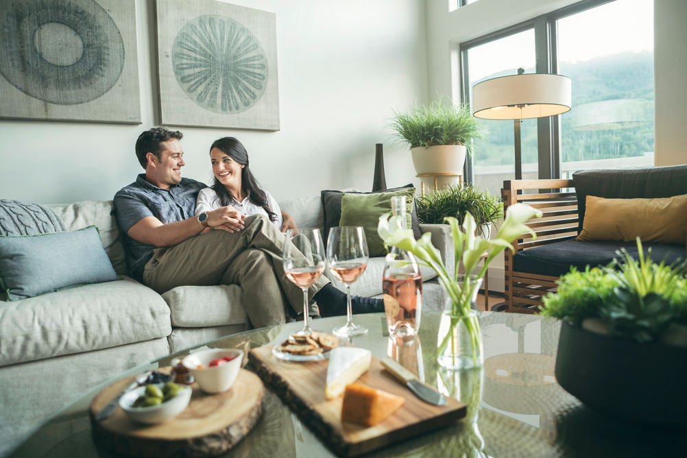 Couple relaxes with wine and cheese at The St James in Beaver Creek, CO.