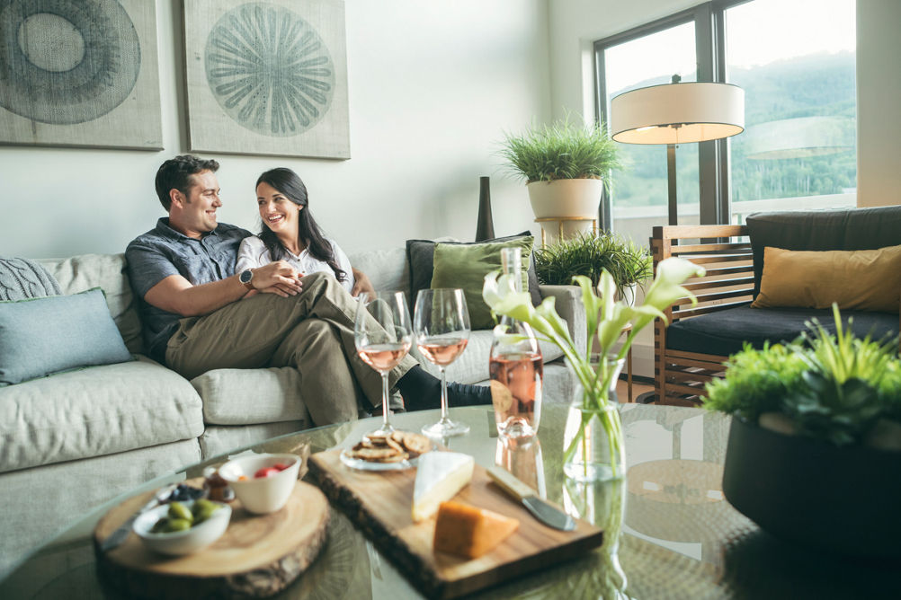 Couple relaxes with wine and cheese at The St James in Beaver Creek, CO.