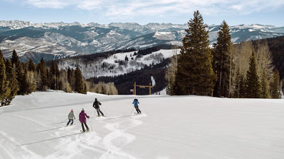 Family skis on a bluebird day in Beaver Creek, CO.