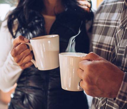 A couple enjoys freshly brewed coffee at their lodge in Northstar, CA.