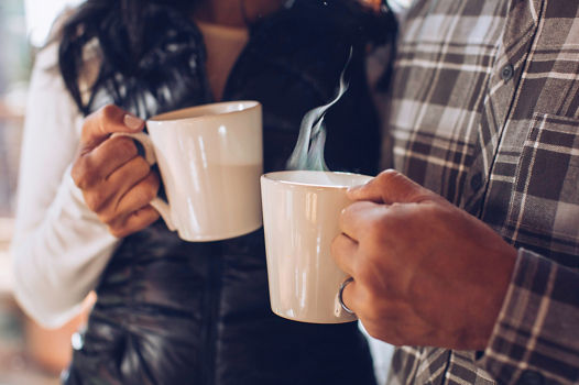 A couple enjoys freshly brewed coffee at their lodge in Northstar, CA.