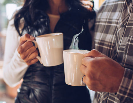 A couple enjoys freshly brewed coffee at their lodge in Northstar, CA.