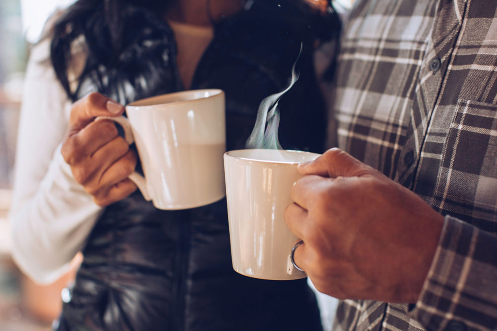 A couple enjoys freshly brewed coffee at their lodge in Northstar, CA.
