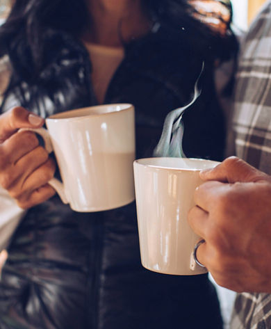 A couple enjoys freshly brewed coffee at their lodge in Northstar, CA.