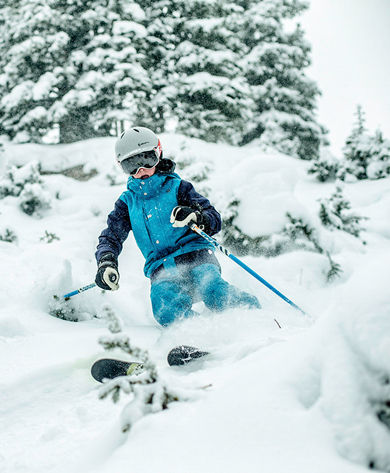 Boy skiing in powder in Vail, CO.