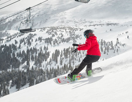 Snowboarders slash powder on Peak 6 at Breck