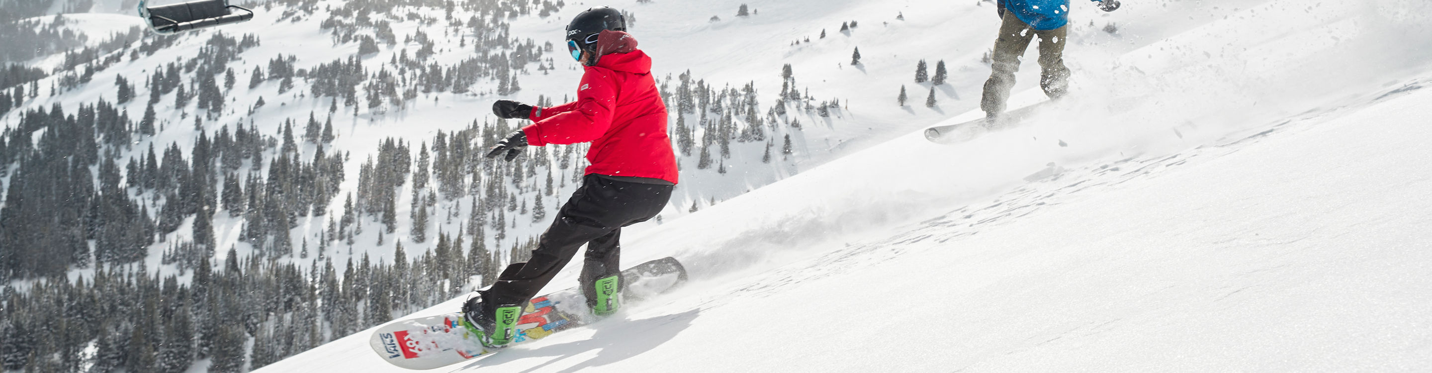 Snowboarders slash powder on Peak 6 at Breck