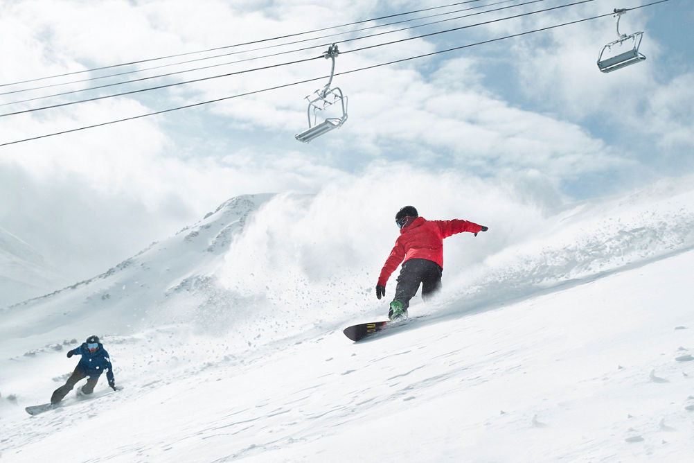 Snowboarders slash powder on Peak 6 at Breck