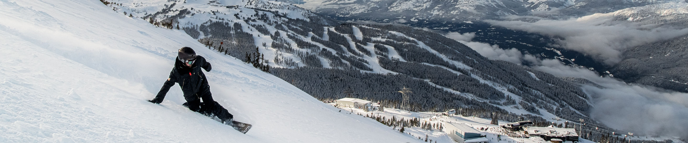 Matt Sylvestre Snowboarding with Whistler Mountain in the background