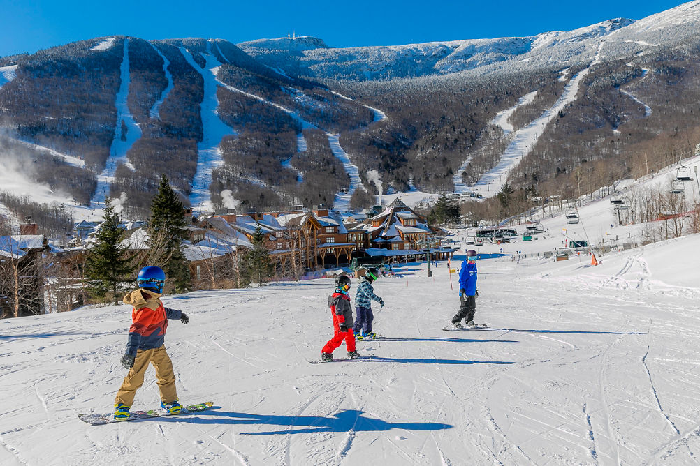 Kids Snowboard Lesson with Female Snowboarder on Spruce Peak at Stowe Mountain Resort 
