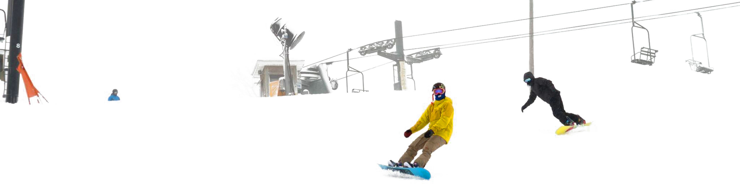 Snowboarder Rides Under Chairlift on Snowy Day at Mad River Mountain