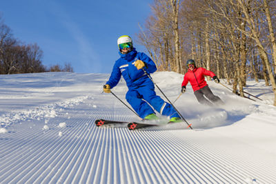 single instructor carving on a corduroy run 