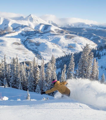 Snowboarding in fresh snow in Crested Butte, CO.