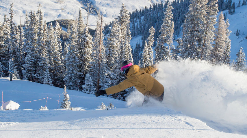 Snowboarding in fresh snow in Crested Butte, CO.