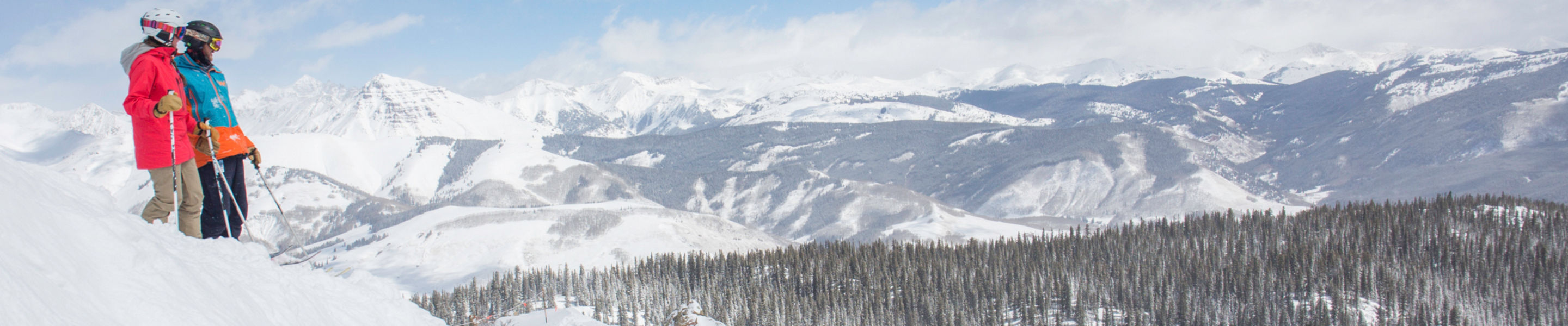 Skiers take in the view on the mountain in Crested Butte, CO.