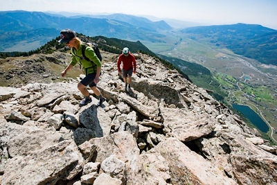 Couple hikes the peak in Crested Butte, CO.