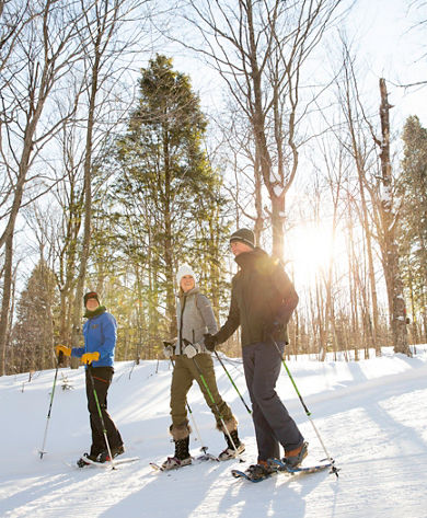 Couple takes a Mountain Hostd snowshoe adventure in Stowe, VT.