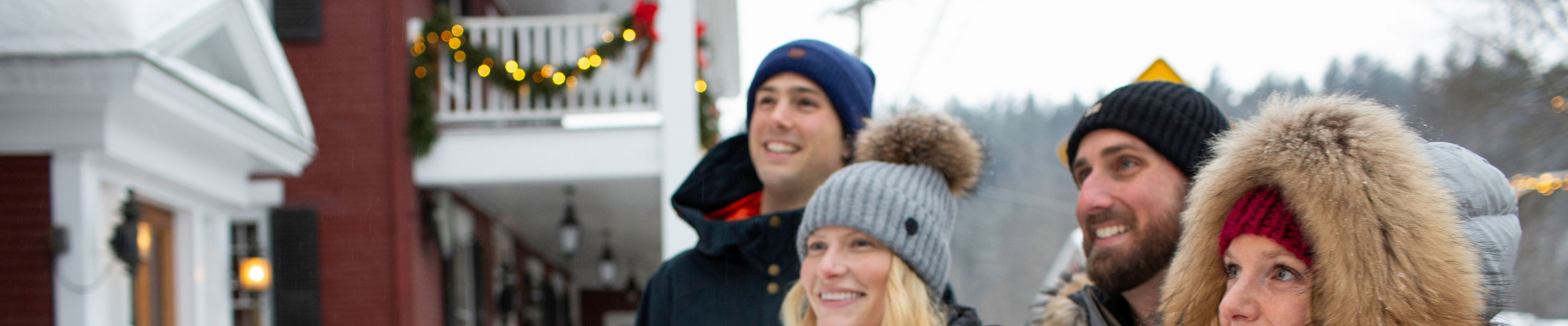 Couples walk around the village exploring storefronts in Stowe, VT.