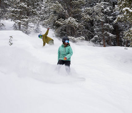 Snowboarders Ride Through Fresh Powder at Breckenridge