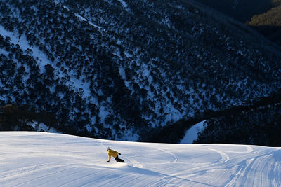 A sole snowboarder descends Heavenly Valley at Hotham