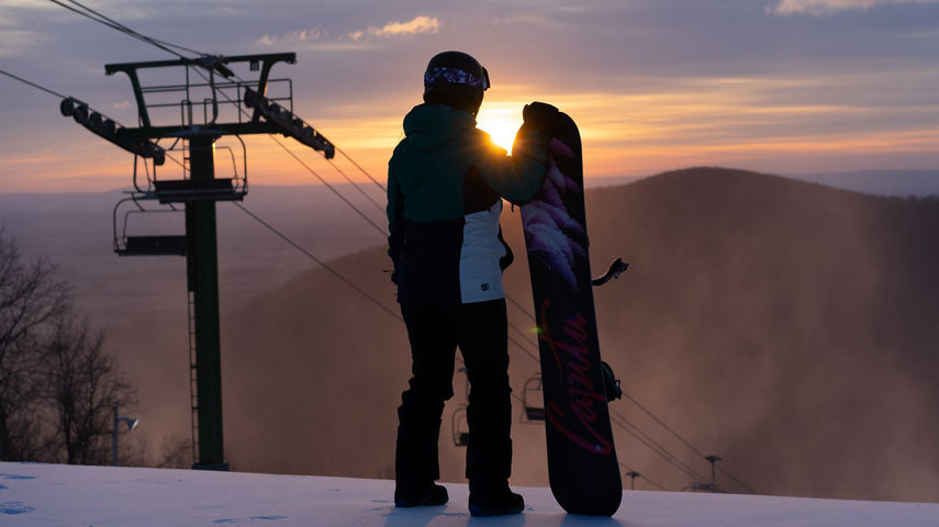 Snowboarder Watches Sunrise at Whitetail 