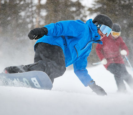 Skier and Snowboarder Make Turns Downhill at Breckenridge