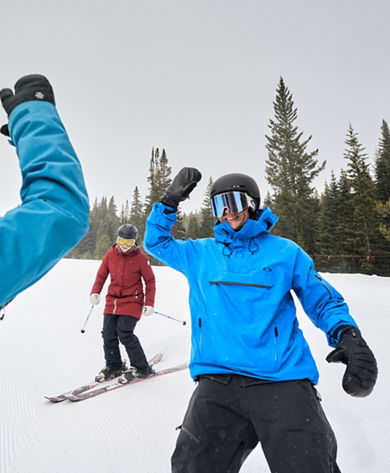 Friends High Five on Ski Run at Breckenridge