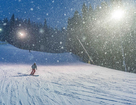 Snow falling during night skiing on Dercum in Keystone, CO.