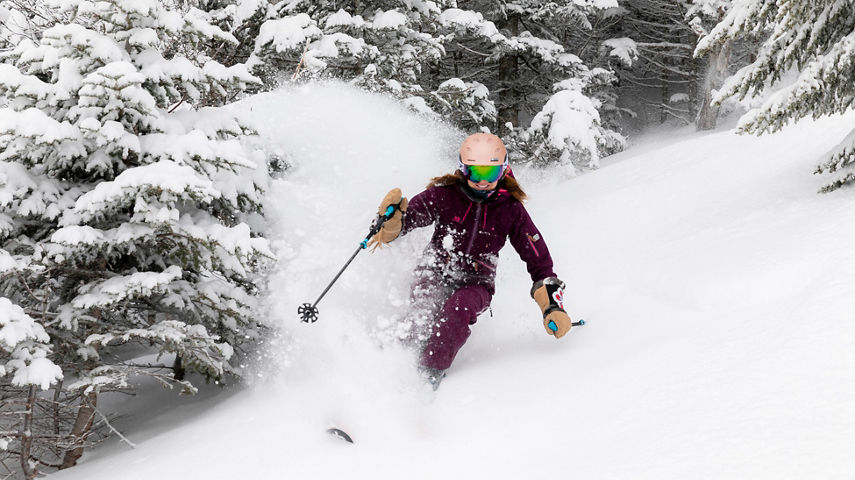 Woman Skiing Through the Trees at Stowe
