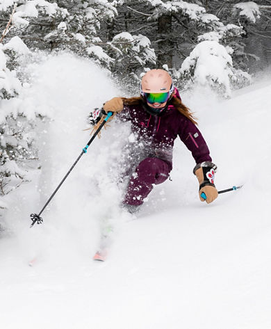 Woman Skiing Through the Trees at Stowe