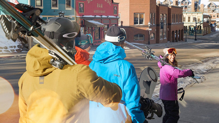 Friends walking through village at Breckenridge, CO.
